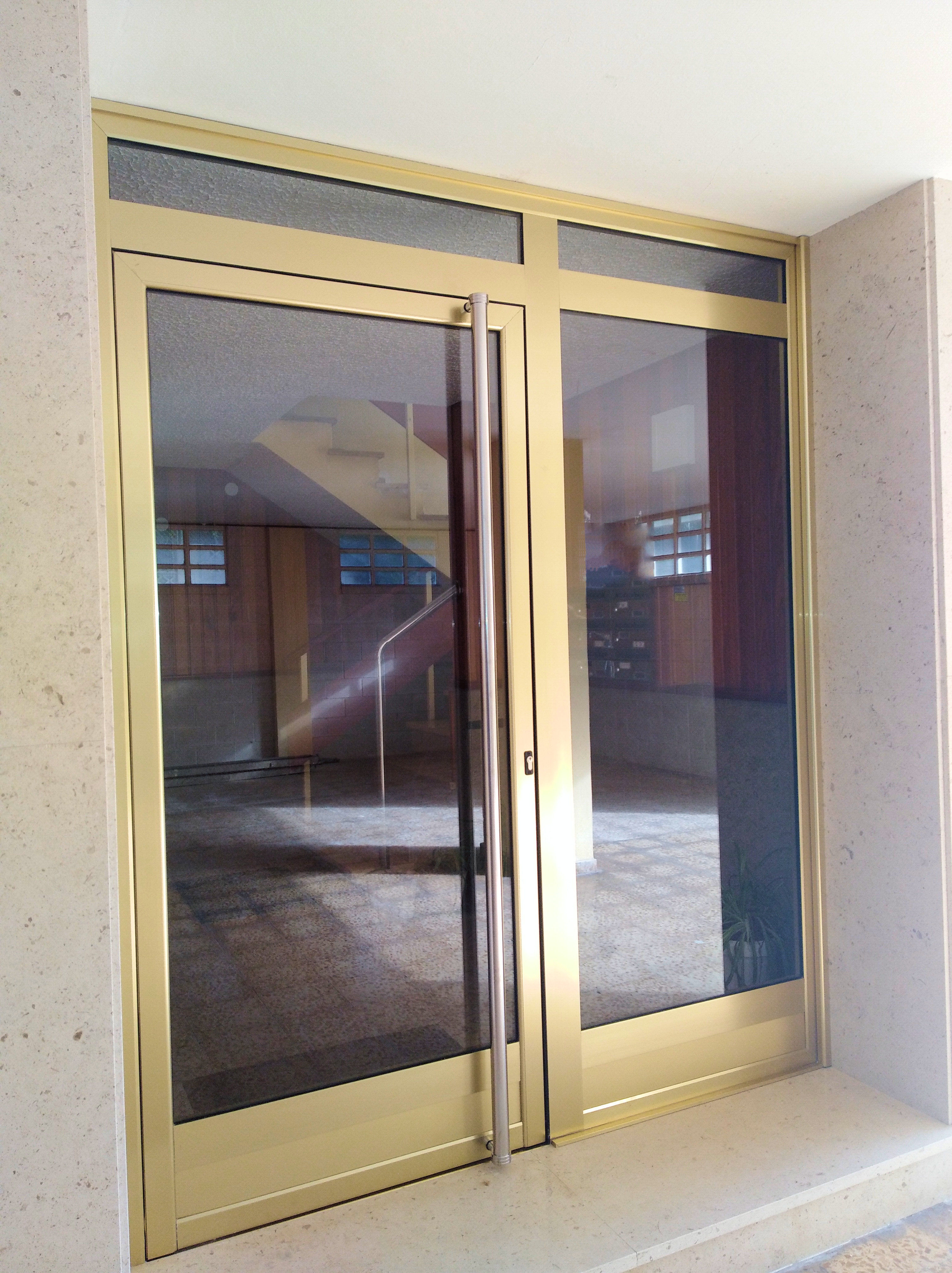 Puerta de portal en aluminio imitación oro en Suances ,Cantabria